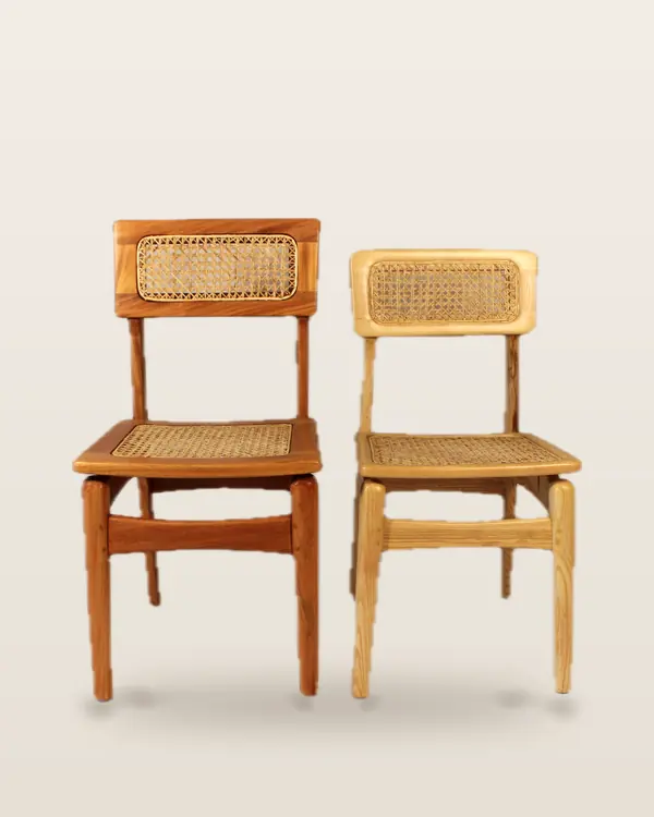 Two cane dining chairs in honey and natural finishes